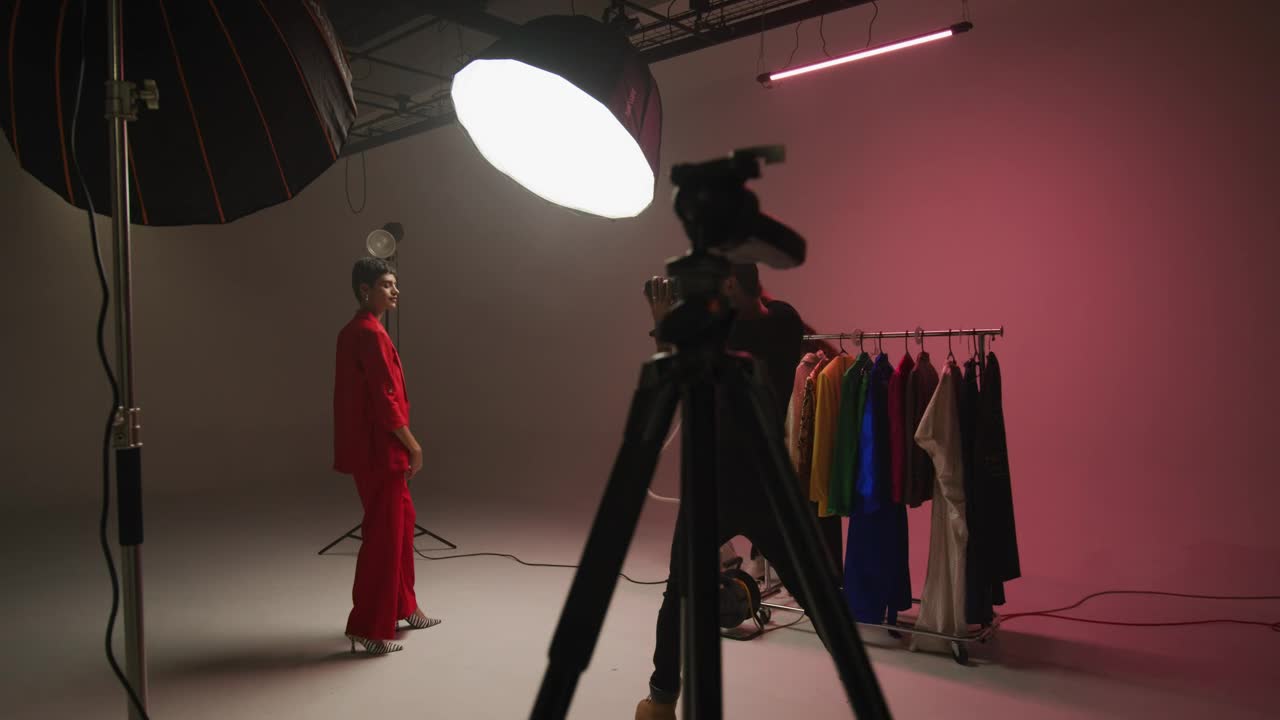 Fashion model and photographer in a studio